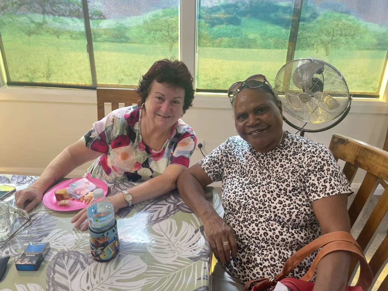 Community members sharing an activity around a table